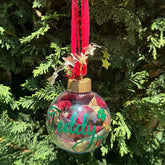 Decorative Christmas ornament with 'Teddy' on a tree